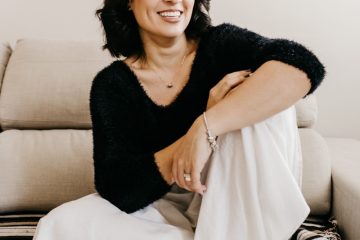 woman in black long sleeve shirt sitting on white couch